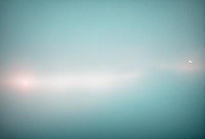 The primary subject of the image is a large, empty, and dark blue sky. The setting is a vast, open space with no visible landmarks or objects. The visual style is a natural, untouched landscape, with no indication of digital manipulation or artistic elements. The colors and mood convey a sense of tranquility and vastness, with the deep blue of the sky providing a striking contrast to the darkness of the surroundings.