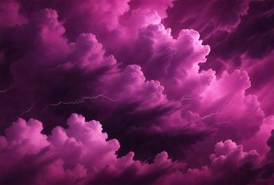 The primary subject of the image is a purple cloudy sky with a few white clouds. The setting is a dark, cloudy sky, and the visual style appears to be a photo. The dominant colors are purple and white, creating a moody and dramatic atmosphere.