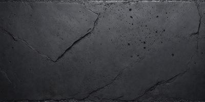 The primary subject of the image is a large, cracked concrete surface. The setting is an outdoor environment, with the concrete surface being the main focus of the image. The visual style is a black and white photo, which adds a sense of depth and contrast to the scene. The colors and mood of the image are predominantly dark and moody, with the cracked concrete surface creating a sense of age and wear.