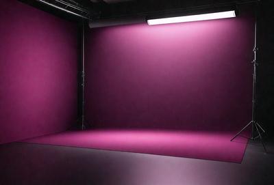 The primary subject of the image is a large pink background, which is likely a backdrop for a photo shoot or a film set. The setting appears to be a studio or a similar indoor environment. The visual style of the image is a close-up of the pink background, which gives a sense of depth and focus to the scene. The colors and mood of the image are predominantly pink, creating a warm and inviting atmosphere.