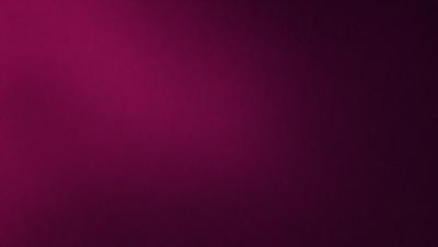 The primary subject of the image is a large, purple wall. The setting is a room with a pink background, which creates a contrasting and vibrant atmosphere. The visual style is a close-up of the wall, showcasing its color and texture. The dominant colors are purple and pink, giving the scene a warm and inviting mood.
