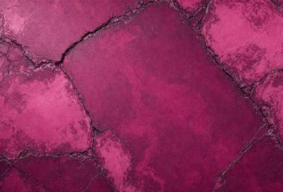 The primary subject of the image is a close-up of a purple surface, which appears to be a piece of leather or a similar material. The setting is a room with a purple wall, and the visual style is a close-up of the purple surface. The colors and mood of the image are predominantly purple, creating a calm and soothing atmosphere.