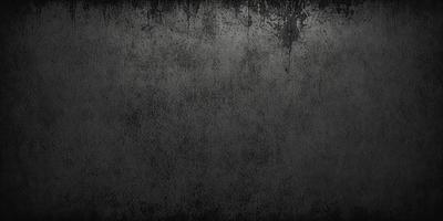 The primary subject of the image is a black and white photo of a wall. The setting is a room with a wall that has a black and white texture. The visual style is a black and white photo, which gives the image a classic and timeless appearance. The colors and mood of the image are predominantly black and white, creating a sense of depth and contrast.