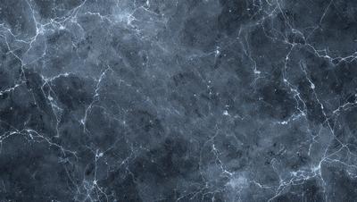 The primary subject of the image is a close-up of a marble wall with a blue tint. The setting is a dark room, and the visual style is a photo. The dominant colors are blue and gray, creating a moody atmosphere.