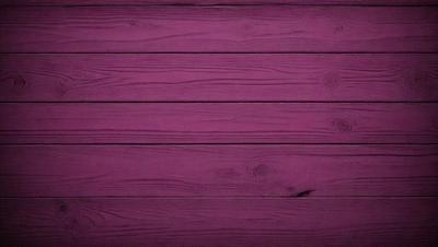 The primary subject of the image is a purple wooden wall. The setting is a room with a wooden floor, and the visual style is a close-up of the wooden wall. The dominant colors are purple and brown, creating a warm and cozy atmosphere.