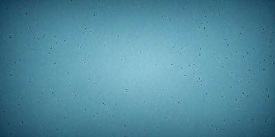 The primary subject of the image is a blue background with a pattern of dots. The setting is a blue wall, and the visual style appears to be a pattern or texture. The colors and mood of the image are predominantly blue, creating a calm and serene atmosphere.