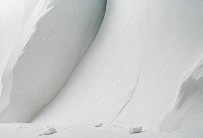 The image features a large, curved, white wall with a smooth, rocky texture. The wall appears to be made of marble or a similar material, giving it a luxurious and elegant appearance. The primary subject of the image is the impressive wall, which serves as the main focus of the scene. The setting is a room with a white background, which further emphasizes the striking appearance of the wall. The visual style of the image is a close-up shot, allowing the viewer to appreciate the intricate details of the wall's texture. The colors and mood of the image are predominantly white, creating a clean, serene, and sophisticated atmosphere.