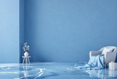 The primary subject of the image is a chair placed in a room with a blue wall. The chair is positioned in front of a vase with flowers, creating a cozy and inviting atmosphere. The setting appears to be a bedroom, as there is a bed visible in the room. The visual style of the image is a photo, capturing the details of the chair, vase, and flowers. The dominant colors in the image are blue and white, giving the room a calm and serene ambiance.