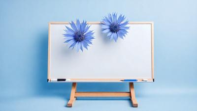 The primary subject of the image is a whiteboard with blue flowers attached to it. The setting is a blue background, and the visual style appears to be a photo. The colors and mood of the image are predominantly blue, creating a calm and serene atmosphere.