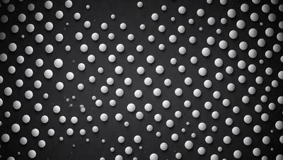 The primary subject of the image is a pattern of white dots on a black background. The dots are scattered throughout the scene, creating a visually interesting and somewhat abstract design. The setting appears to be a black surface, possibly a wall or a piece of fabric, with the white dots standing out against it. The visual style of the image is a combination of digital art and illustration, as the dots are evenly spaced and the overall composition is well-organized. The colors and mood of the image are predominantly black and white, with the white dots providing a sense of contrast and depth.
