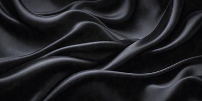 The primary subject of the image is a black fabric, which appears to be a piece of cloth or a curtain. The setting is a dark room, and the visual style is a close-up of the fabric. The colors and mood of the image are predominantly black, creating a moody and dramatic atmosphere.