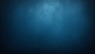 The primary subject of the image is a blue background with a few white specks. The setting is a dark room, and the visual style is a close-up of the blue background. The colors and mood of the image are predominantly dark and moody, with the blue background providing a sense of depth and contrast.
