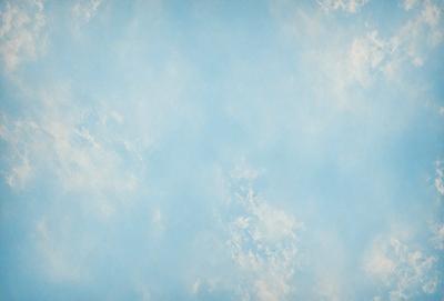 The primary subject of the image is a blue sky with clouds. The setting is a cloudy sky, and the visual style is a photo. The dominant colors are blue and white, creating a calm and serene atmosphere.