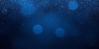 The primary subject of the image is a group of three blue circles, which are the main objects in the scene. The setting is a dark, starry night sky, with the circles floating against the backdrop of the night sky. The visual style of the image is a combination of a photo and digital art, creating a unique and captivating atmosphere. The dominant colors in the image are blue and black, with the blue circles standing out against the dark sky. The overall mood of the image is serene and peaceful, as the circles float in the vastness of the night sky.
