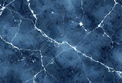 The primary subject of the image is a blue and white marbled wall. The setting is a room with a blue and white marbled wall as the main focus. The visual style is a close-up of the marbled wall, showcasing its intricate patterns. The colors and mood of the image are predominantly blue and white, creating a calm and elegant atmosphere.