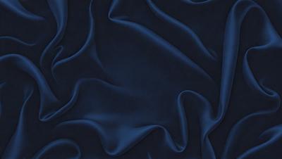 The primary subject of the image is a blue fabric, which appears to be a piece of cloth or a curtain. The setting is a dark room, and the visual style is a close-up of the blue fabric. The colors and mood of the image are predominantly dark and moody, with the blue fabric being the main focus.