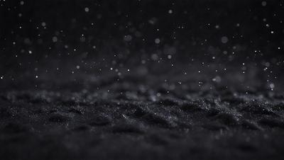 The primary subject of the image is a black background with a pattern of white stars. The setting is a dark, starry night, and the visual style is a black and white photo. The dominant colors are black and white, creating a moody and dramatic atmosphere.