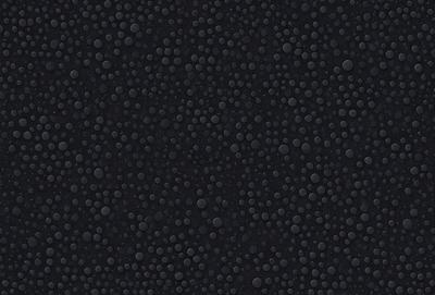 The primary subject of the image is a close-up of a black surface with a pattern of small bubbles. The setting is a dark room, and the visual style appears to be a photo. The dominant colors are black and white, and the overall atmosphere is somewhat mysterious and intriguing.
