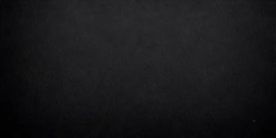 The primary subject of the image is a black background. The setting is a dark room, and the visual style is a black and white photo. The colors and mood of the image are dark and moody, creating a sense of mystery or drama.