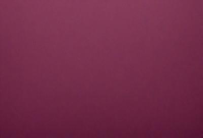 The primary subject of the image is a large, purple wall. The setting is a room with a pink background. The visual style is a close-up of the wall, which gives a sense of depth and texture. The colors and mood of the image are predominantly pink, creating a warm and inviting atmosphere.