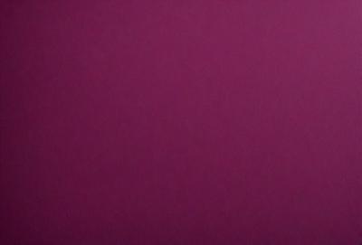 The primary subject of the image is a large, purple wall. The setting is a room with a pink background. The visual style is a close-up of the wall, showcasing its color and texture. The dominant colors are purple and pink, creating a warm and inviting atmosphere.