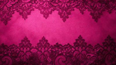 The primary subject of the image is a pink lace fabric with a pattern of intricate designs. The setting is a pink background, which complements the lace fabric. The visual style is a close-up of the lace fabric, showcasing its intricate details. The colors and mood of the image are predominantly pink, creating a warm and elegant atmosphere.