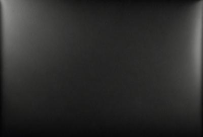 The primary subject of the image is a black background. The setting is a dark, empty space with no visible objects or details. The visual style is a black and white photo, which gives the image a classic and timeless appearance. The colors and mood are predominantly dark and moody, creating a sense of mystery and depth.