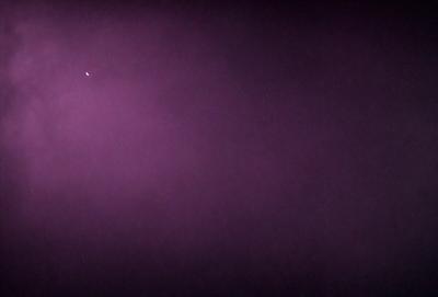 The image features a purple background with a few stars visible in the sky. The purple hue creates a unique and artistic atmosphere. The stars are scattered throughout the scene, adding a sense of depth and dimension to the image. The combination of the purple background and the stars in the sky creates a visually striking and memorable scene.