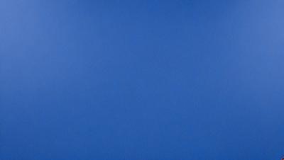 The primary subject of the image is a large, open blue sky. The setting is a vast, cloudless expanse, with no visible landmarks or objects. The visual style is a natural, untouched landscape, with no indication of digital manipulation or artistic elements. The colors and mood are predominantly blue, creating a serene and peaceful atmosphere.