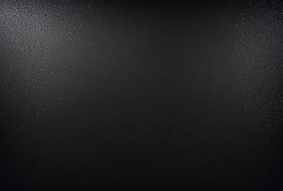The image is a black and white photo of a dark background. The primary subject is a bright light source, which appears to be a star or a light bulb. The setting is a dark room, and the visual style is a simple, monochromatic composition. The colors and mood of the image are predominantly dark and moody, with the bright light source standing out against the black background.