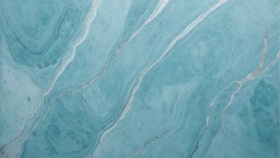 The primary subject of the image is a blue and white marbled tile. The setting is a bathroom, as the tile is placed on a wall. The visual style is a photo, capturing the intricate patterns and textures of the marbled tile. The dominant colors are blue and white, creating a calm and soothing atmosphere in the bathroom.