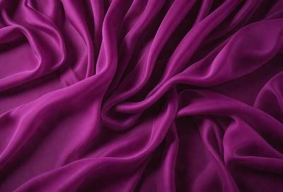 The primary subject of the image is a purple fabric, which is the main object, scene, or focus of the image. The setting or background is a purple sheet, and the visual style is a photo. The colors and mood of the image are predominantly purple, creating a calm and serene atmosphere.