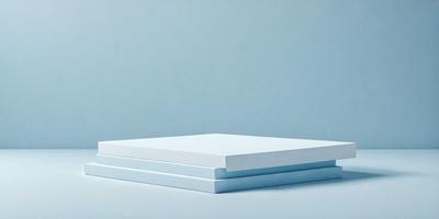 The primary subject of the image is a stack of three white square pieces, possibly made of paper or cardboard. The setting is a blue background, which creates a contrasting and visually appealing environment. The visual style of the image is a close-up, focusing on the details of the stacked pieces. The colors and mood of the image are predominantly blue, giving it a calm and serene atmosphere.
