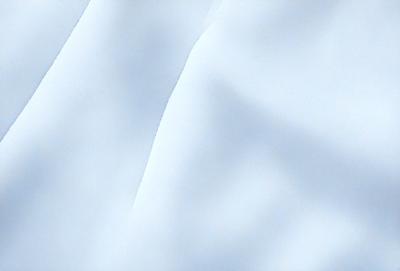 The primary subject of the image is a white, snowy surface. The setting is a cloudy sky, and the visual style is a photo. The dominant colors are white and blue, creating a calm and serene atmosphere.