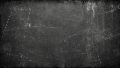 The primary subject of the image is a black and white photograph of a wall. The setting is a room with a wall that appears to be made of concrete. The visual style is a black and white photograph, which gives the image a classic and timeless appearance. The colors and mood of the image are predominantly dark and moody, with the black and white tones adding to the overall atmosphere.