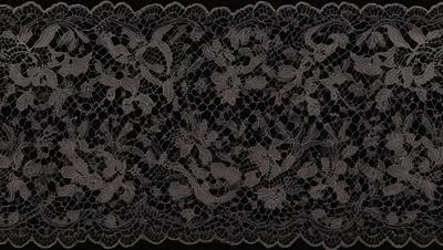 The primary subject of the image is a black and white lace pattern. The setting is a black background, which contrasts with the lace pattern. The visual style is a close-up of the lace pattern, showcasing its intricate details. The colors and mood of the image are predominantly dark and moody, with the lace pattern serving as the focal point.