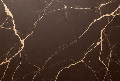 The primary subject of the image is a marble countertop with a brown and gold color scheme. The setting is a kitchen, and the visual style is a close-up of the countertop. The countertop has a patterned texture, giving it a unique and elegant appearance. The colors and mood of the image are warm and inviting, creating a cozy and sophisticated atmosphere.