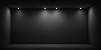 The primary subject of the image is a large, empty room with a black wall. The setting is a dark room with a black background, creating a moody atmosphere. The visual style is a black and white photo, which adds a sense of drama and contrast to the scene. The colors and mood of the image are predominantly dark, with the black wall and room creating a sense of emptiness and mystery.