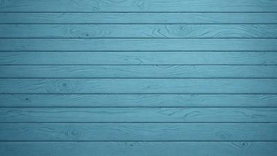 The primary subject of the image is a blue wooden wall. The setting is a room with a blue wooden wall, and the visual style is a photo. The dominant colors are blue and wood, creating a calm and serene atmosphere.