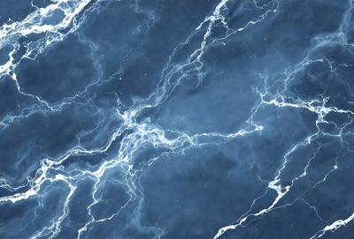 The primary subject of the image is a blue marble wall with a pattern of white and blue swirls. The setting is a room with a blue marble countertop. The visual style is a close-up of the marble wall, showcasing the intricate swirl pattern. The colors and mood of the image are predominantly blue, creating a calm and serene atmosphere.