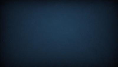 The primary subject of the image is a dark blue sky. The setting is a vast, open space with no visible landmarks or objects. The visual style is a black and white photo, which adds a sense of timelessness and simplicity to the scene. The colors and mood are predominantly dark and moody, with the blue sky serving as the main focal point.