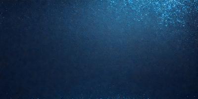 The primary subject of the image is a large, dark blue surface. The setting is a dark blue background, and the visual style is a close-up of the blue surface. The colors and mood of the image are predominantly dark and moody, with the blue surface being the main focus.