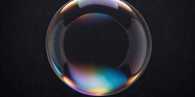The primary subject of the image is a large, colorful bubble floating on a dark surface. The bubble is filled with a vibrant mix of colors, creating a visually striking scene. The setting appears to be a black background, which contrasts with the bubble's vivid hues. The visual style of the image is a close-up, focusing on the bubble's details and textures. The overall atmosphere of the image is lively and captivating, with the bubble's vibrant colors and the dark background creating a striking contrast.