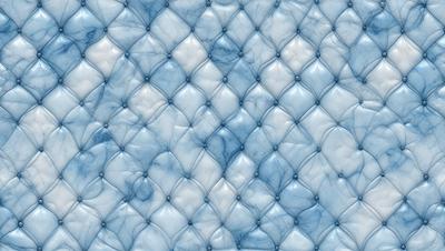 The primary subject of the image is a blue and white couch with a leather-like texture. The setting is a room with a blue background, which adds to the overall atmosphere. The visual style is a close-up of the couch, showcasing its unique design and texture. The colors and mood of the image are predominantly blue, creating a calm and relaxing environment.