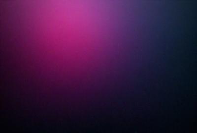 The primary subject of the image is a pink background. The setting is a dark, empty room with a purple hue. The visual style is a close-up of the pink background, creating a striking contrast with the darker surroundings. The colors and mood of the image are predominantly pink and purple, giving it a vibrant and moody atmosphere.