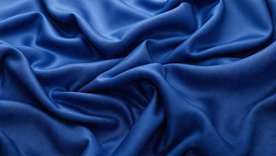 The primary subject of the image is a blue fabric, which is the main object, scene, or focus of the image. The setting or background is a blue cloth, and the visual style is a photo. The dominant colors and overall atmosphere are blue and serene.