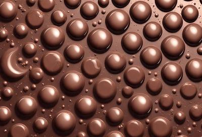 The primary subject of the image is a close-up of a chocolate surface, possibly a chocolate cake or a chocolate-covered item. The setting is a chocolate-themed background, which adds to the overall atmosphere of the image. The visual style is a close-up of the chocolate, showcasing its texture and details. The colors in the image are predominantly brown, which is consistent with the chocolate theme.