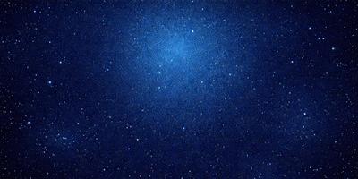 The primary subject of the image is the night sky filled with stars. The setting is a dark, star-filled sky, and the visual style is a photo of the night sky. The colors and mood of the image are predominantly dark and serene, with the stars providing a sense of wonder and tranquility.