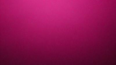 The primary subject of the image is a large, pink wall. The setting is a room with a pink background, and the visual style is a close-up of the wall. The dominant colors in the image are pink, and the overall atmosphere is warm and inviting.