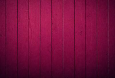 The primary subject of the image is a red wooden wall. The setting is a room with a red wall, and the visual style is a close-up of the wall. The dominant colors are red and purple, creating a warm and inviting atmosphere.